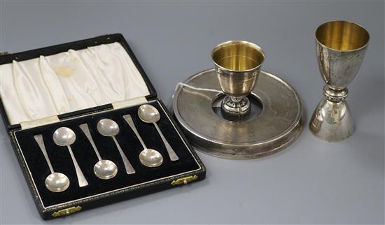 A modern silver champagne cover by Brian Leslie Fuller, a silver single/double measure cup, cased set of silver spoons, etc (4)